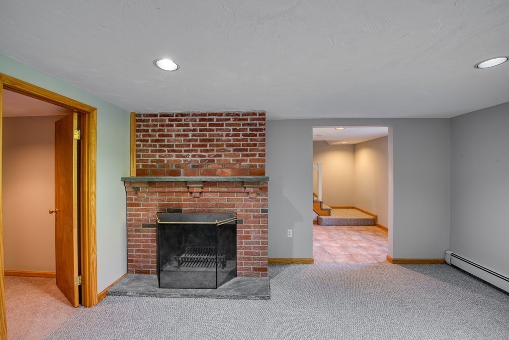 46 Prospect Street Sherborn, MA 01770 - Photo 24 of 40 an empty room with a fireplace and window