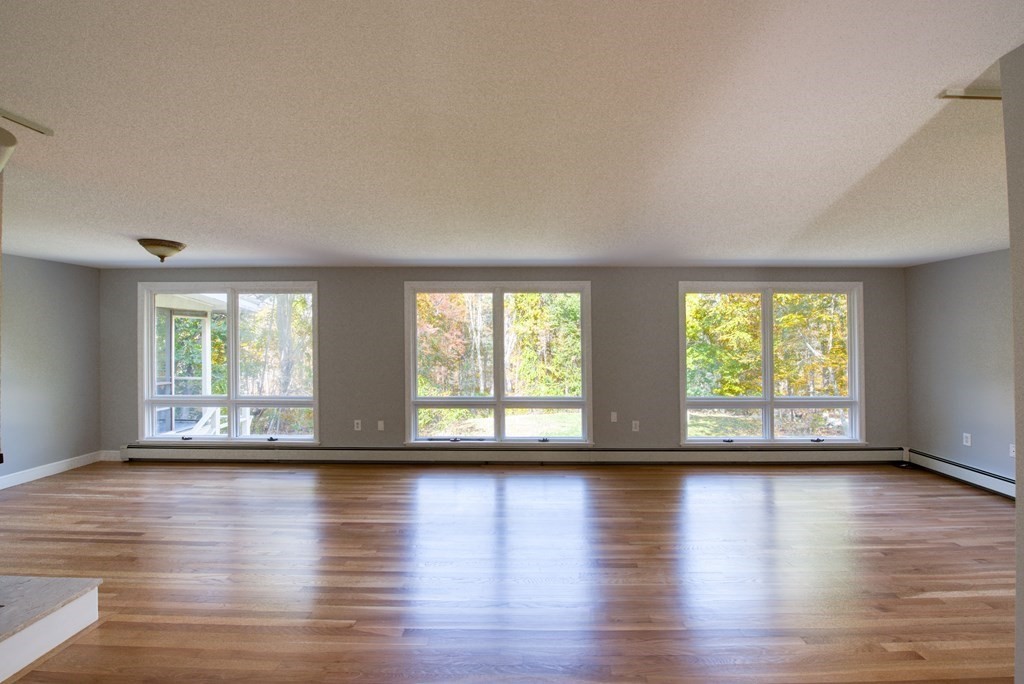 46 Prospect Street Sherborn, MA 01770 - Photo 5 of 40 a view of empty room with wooden floor and fan