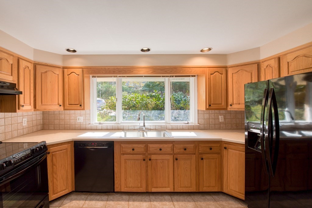 46 Prospect Street Sherborn, MA 01770 - Photo 9 of 40 a kitchen with stainless steel appliances granite countertop a sink and a stove