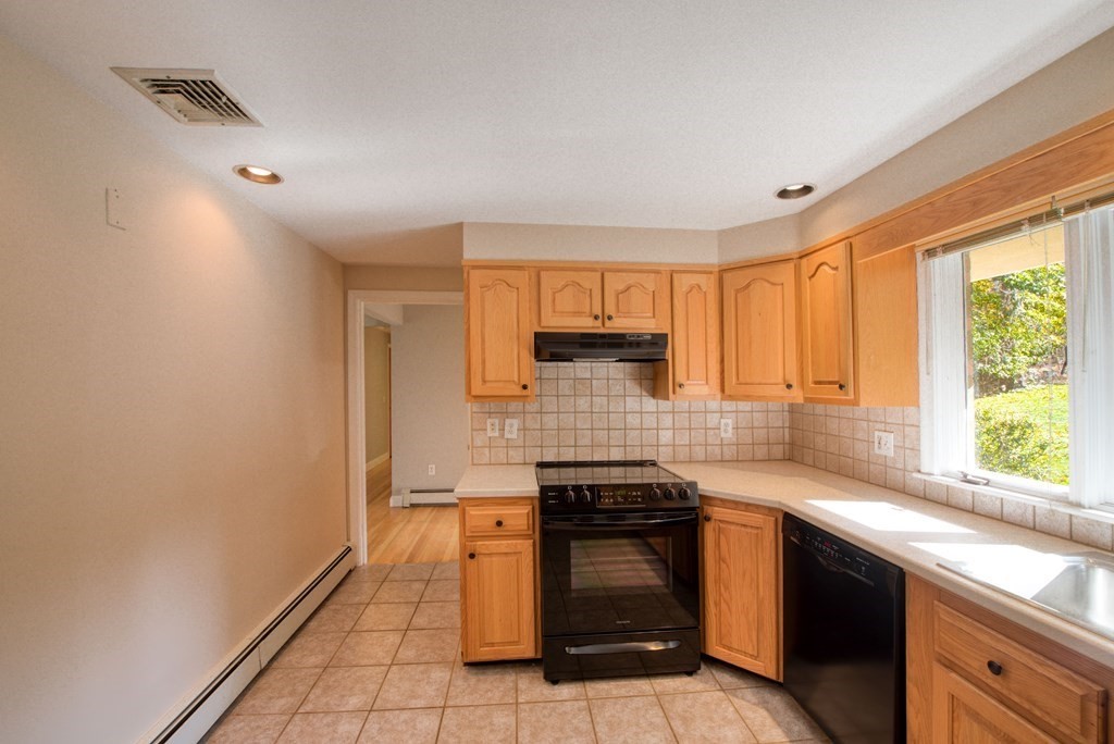46 Prospect Street Sherborn, MA 01770 - Photo 10 of 40 a kitchen with stainless steel appliances granite countertop a stove a sink and a microwave