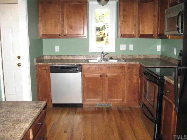 609 Brent Road Raleigh, NC 27606 - Photo 3 of 10 Spacious kitchen with new stainless steel appliances & hardwood floor Other