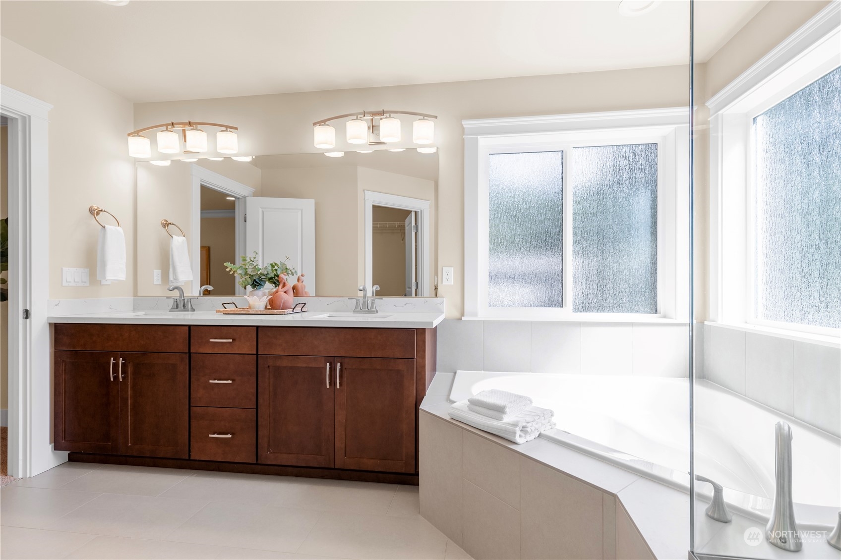 24022 Meridian Avenue South Bothell, WA 98021 - Photo 30 of 36 a bathroom with a tub a double vanity sink and a large mirror