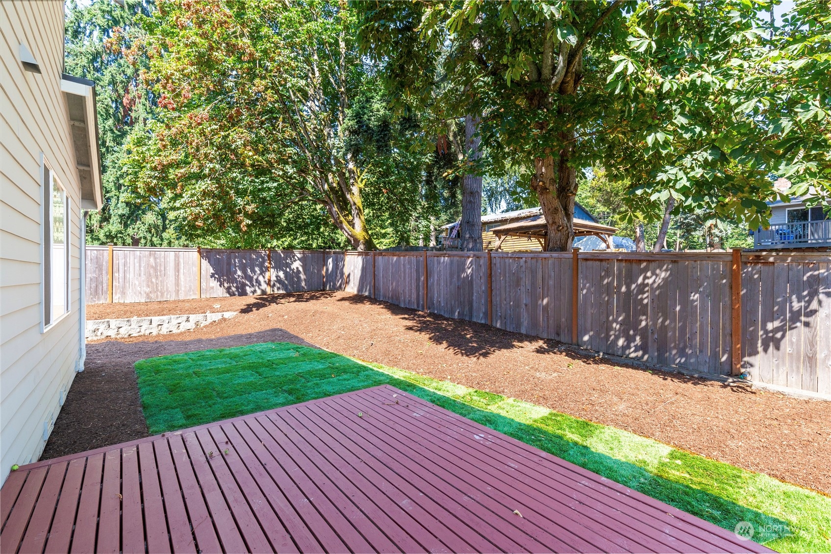 24022 Meridian Avenue South Bothell, WA 98021 - Photo 32 of 36 a view of a backyard with wooden fence and large trees