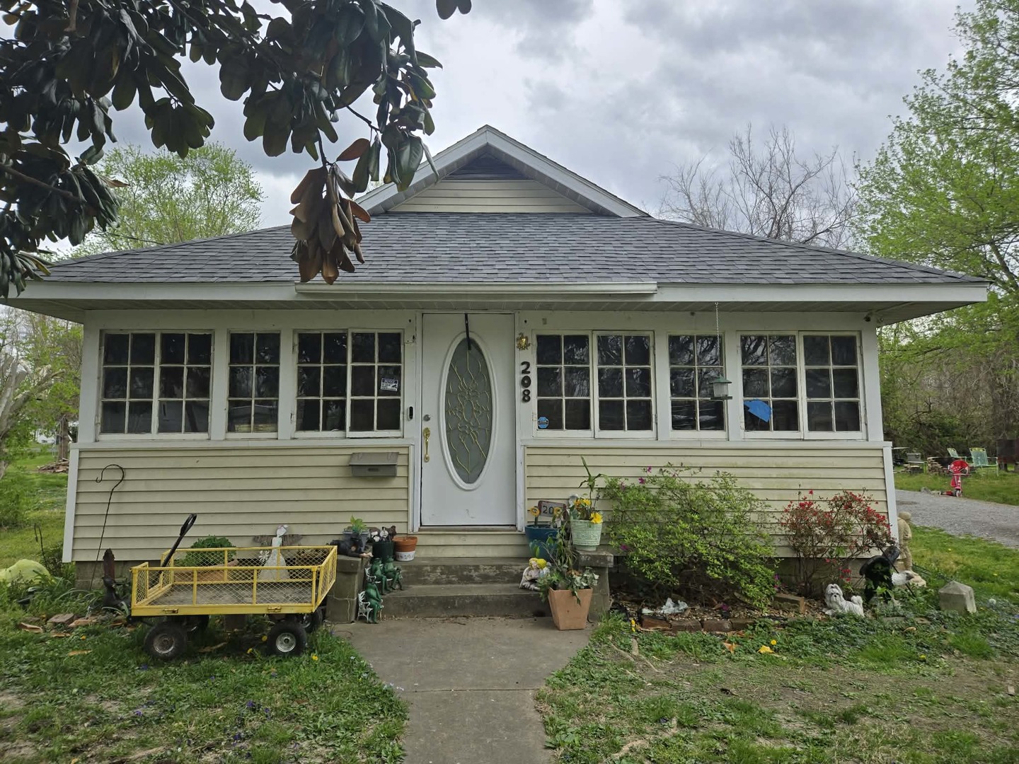 a front view of a house with a yard and outdoor seating