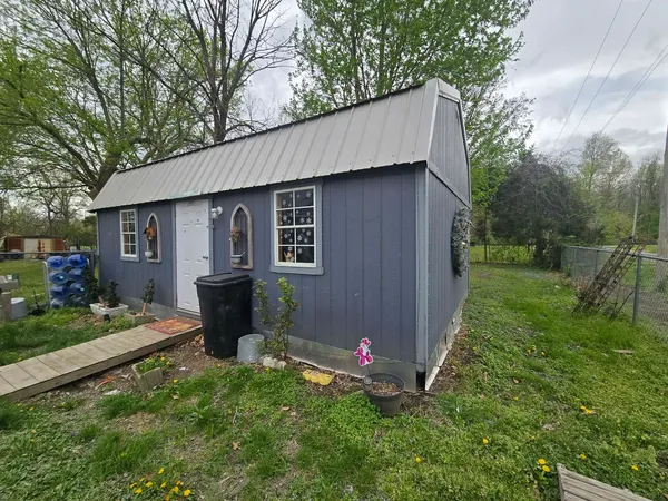 a backyard of a house with table and chairs