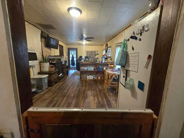 a view of kitchen with furniture and wooden floor