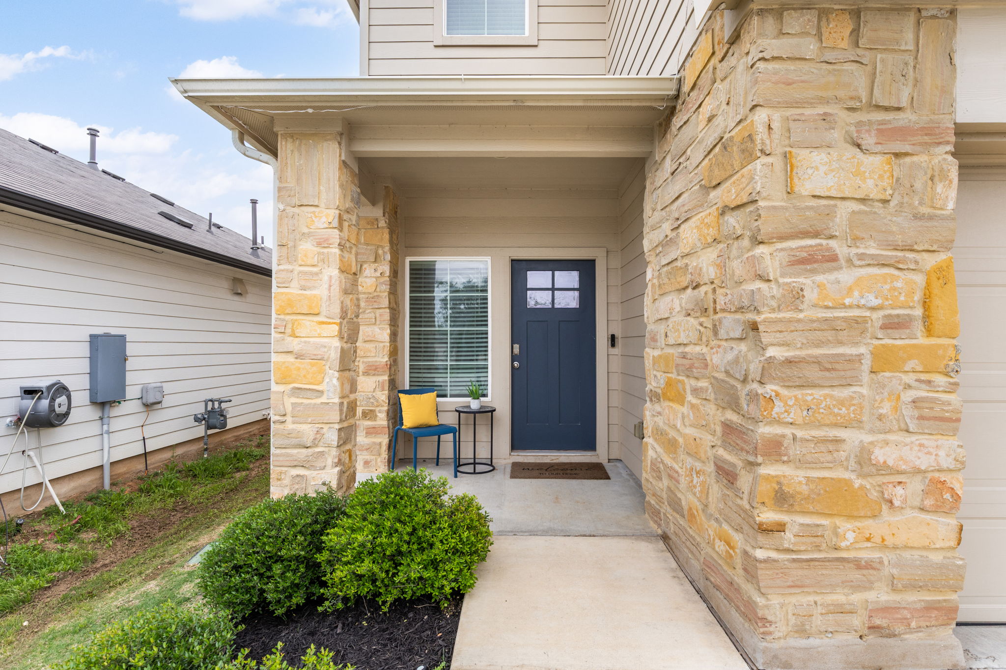 281 Jayden Drive Kyle, TX 78640 - Photo 4 of 36 Stone and siding exterior featuring a covered entry