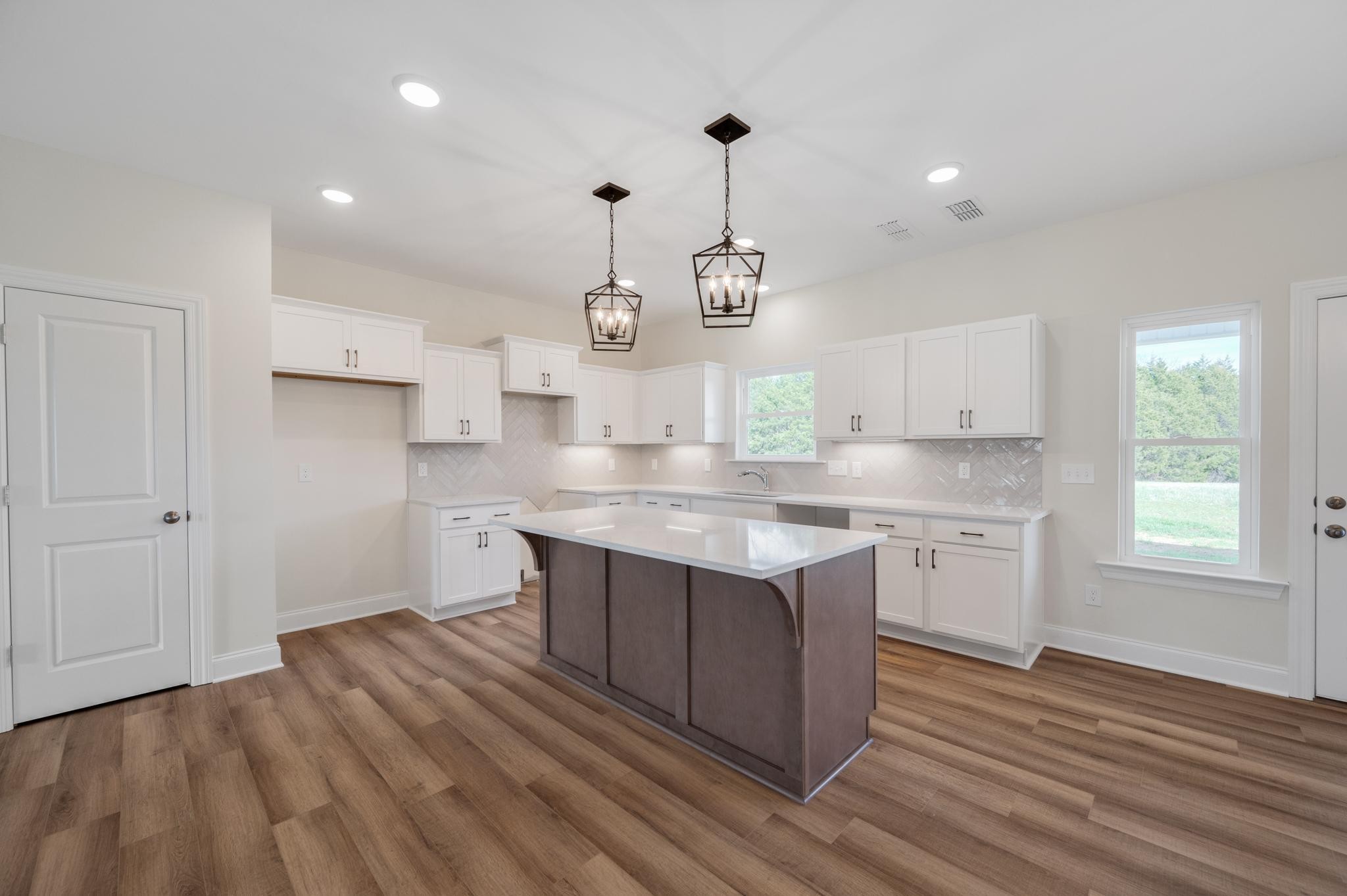 3099 Gwynn Road Lebanon, TN 37090 - Photo 15 of 44 a kitchen with a sink dishwasher white cabinets and wooden floor