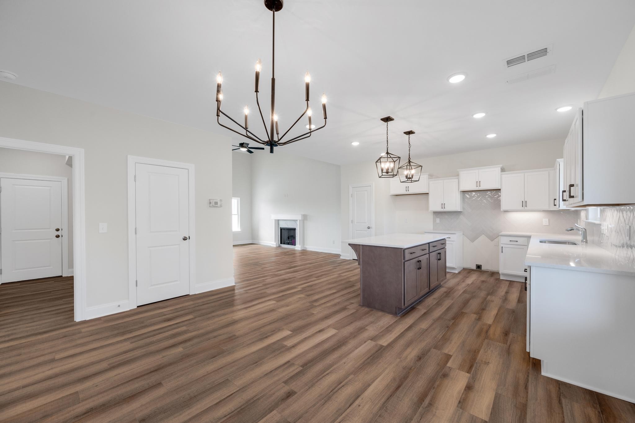 3099 Gwynn Road Lebanon, TN 37090 - Photo 19 of 44 a large kitchen with kitchen island white cabinets and wooden floor