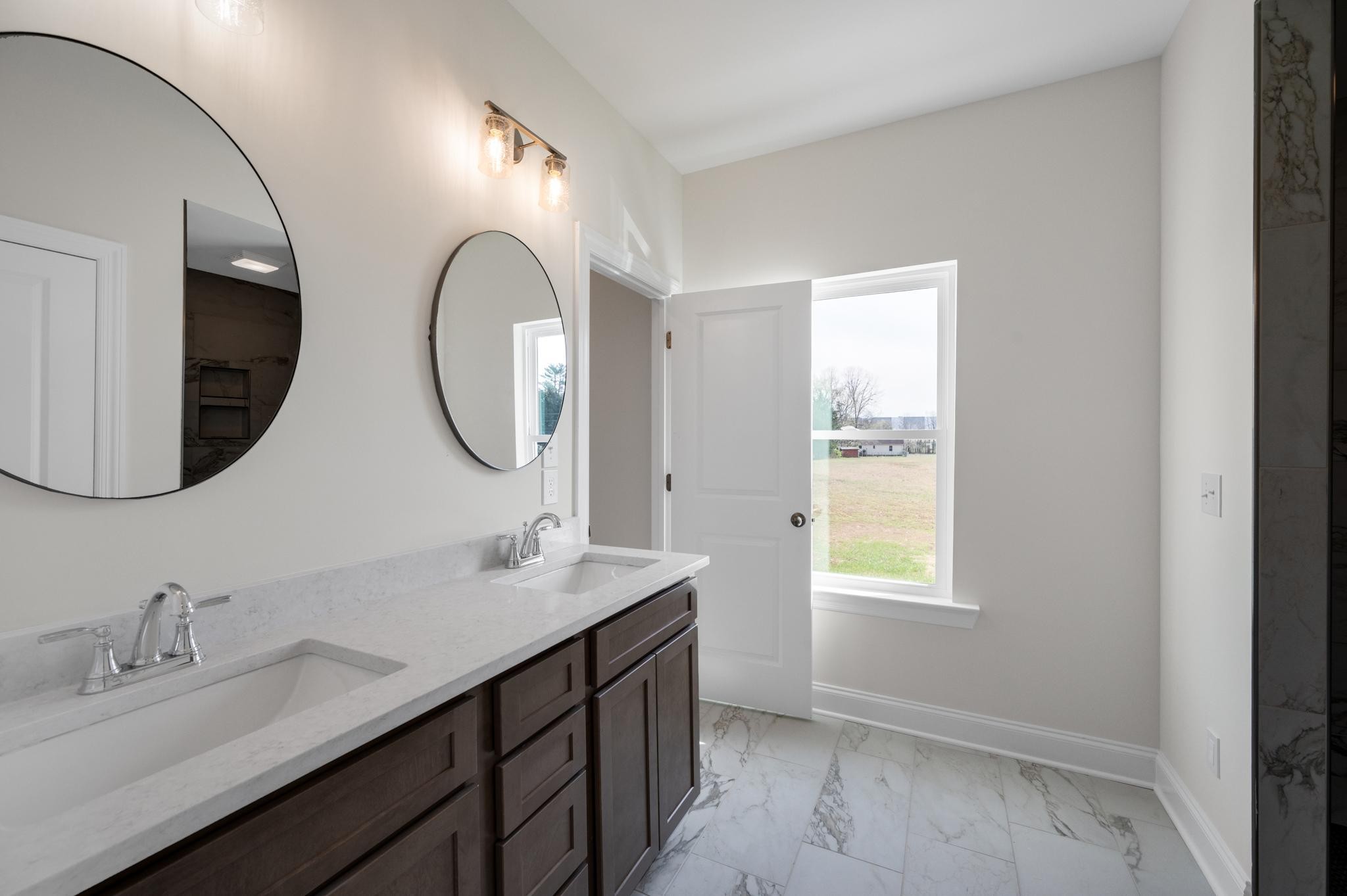 3099 Gwynn Road Lebanon, TN 37090 - Photo 23 of 44 a bathroom with a double vanity sink and a mirror