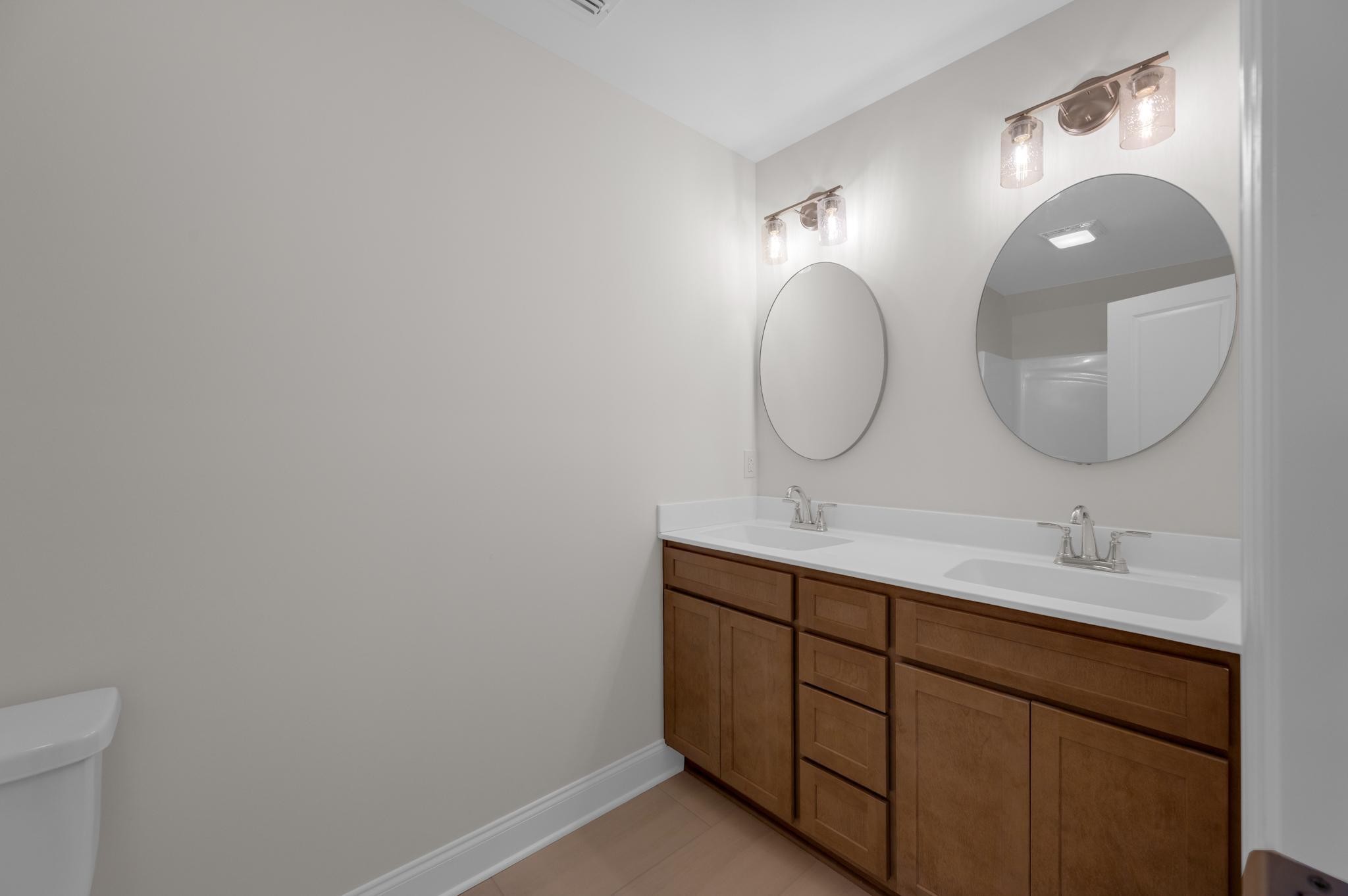 3099 Gwynn Road Lebanon, TN 37090 - Photo 33 of 44 a bathroom with a double vanity sink and a mirror