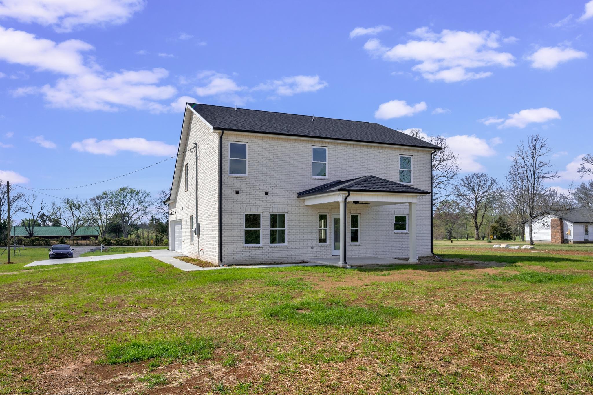 3099 Gwynn Road Lebanon, TN 37090 - Photo 39 of 44 a large white house with a big yard and large trees