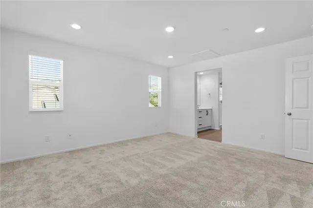 an empty room with windows and closet