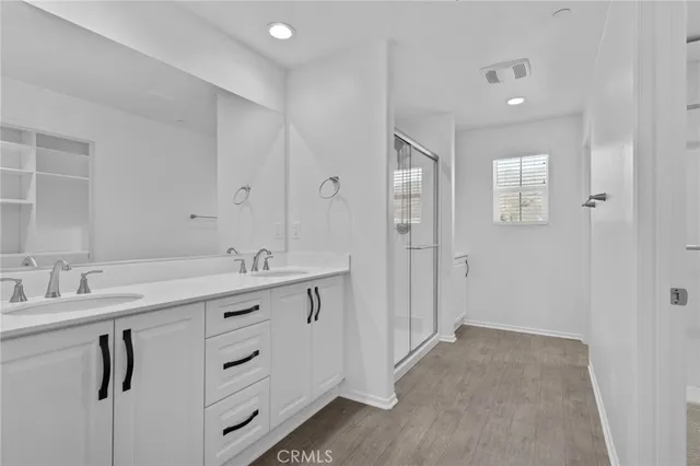 a bathroom with a sink vanity and a mirror