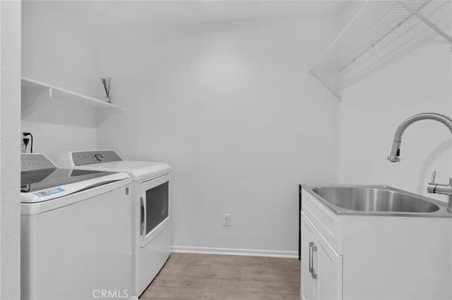 a patio with a glass top table and chairs