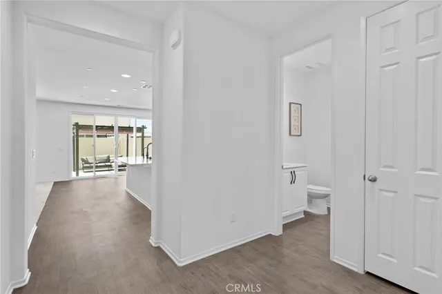 a view of a bathroom with toilet windows and a chandelier