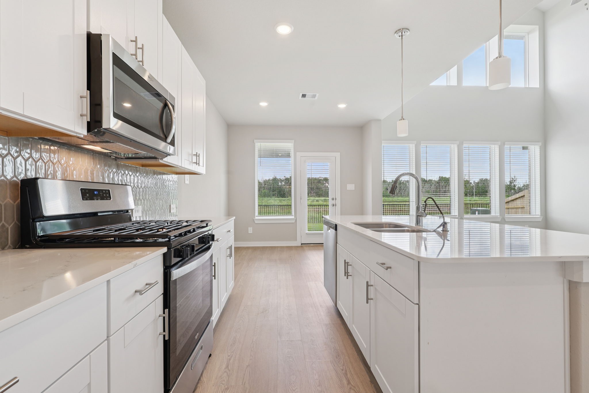 2702 Dark Lantern Drive Rosenberg, TX 77471 - Photo 15 of 39 a large kitchen with stainless steel appliances granite countertop a stove and a sink