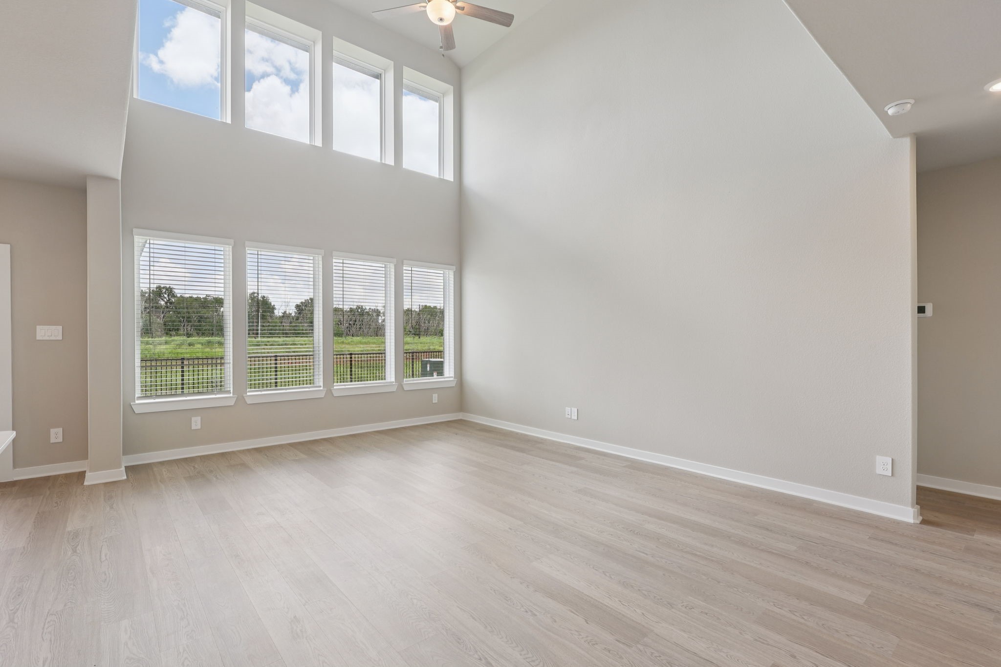 2702 Dark Lantern Drive Rosenberg, TX 77471 - Photo 10 of 39 a view of an empty room with wooden floor and a window