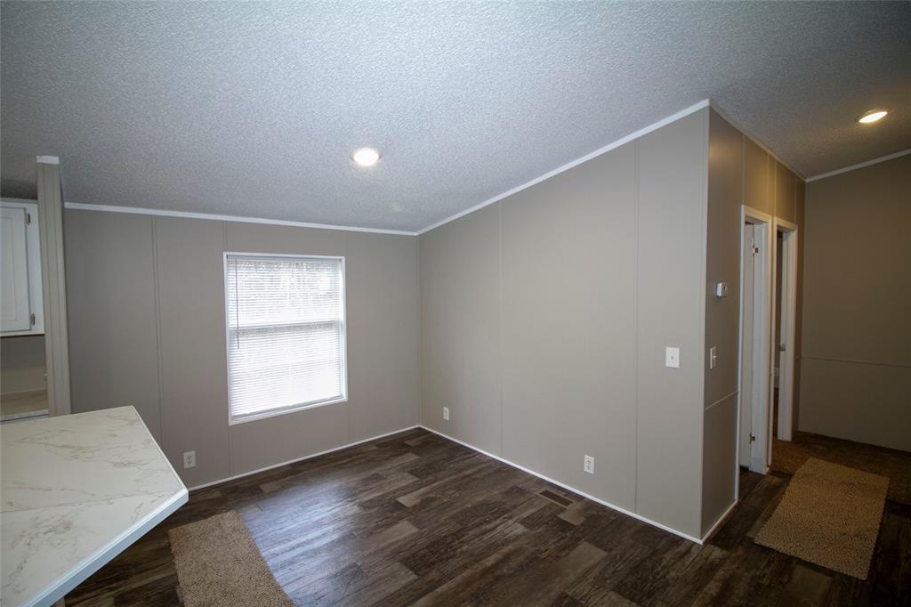 909 Old Arcadia Road Minden, LA 71055 - Photo 6 of 21 an empty room with wooden floor and windows