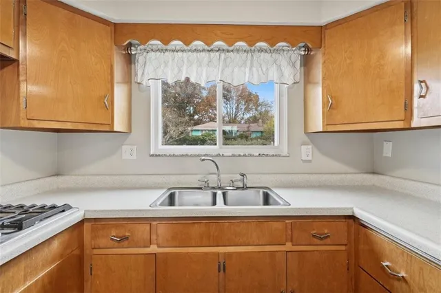 a kitchen with a sink and cabinets