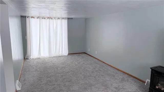 a view of room with window and ceiling fan