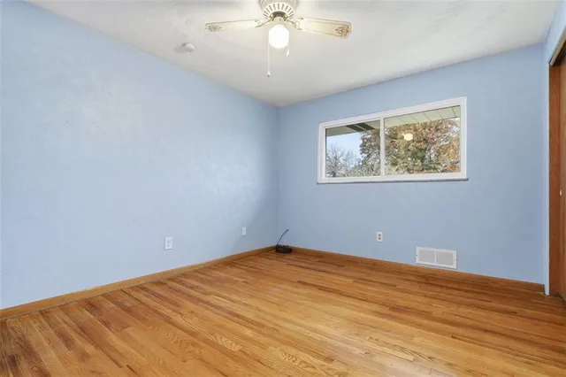 a view of room with window and ceiling fan