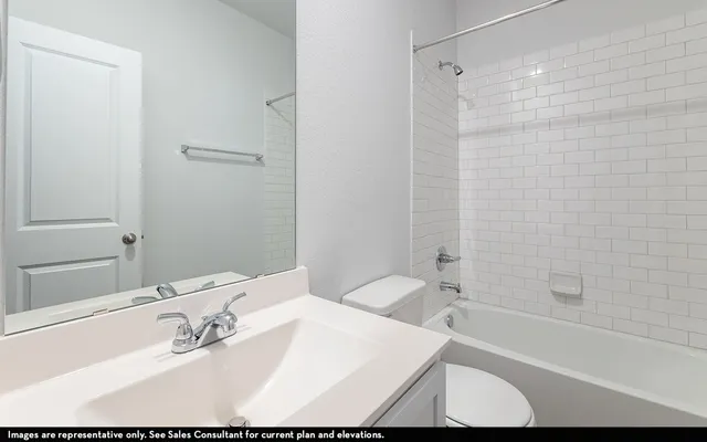 a bathroom with a white bath tub a sink and a shower