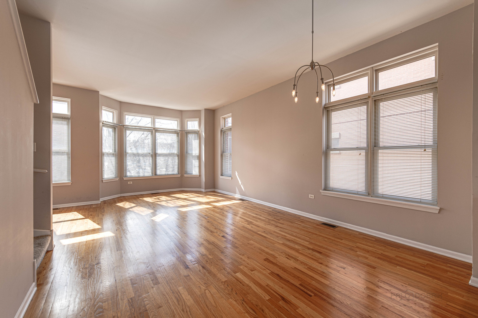 736 West 15th Street Chicago, IL 60607 - Photo 4 of 23 a view of an empty room with wooden floor and a window