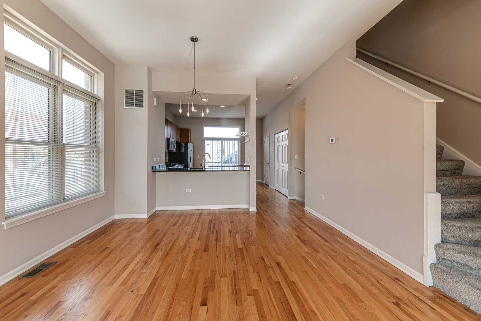 736 West 15th Street Chicago, IL 60607 - Photo 5 of 23 a view of a big room with wooden floor and windows