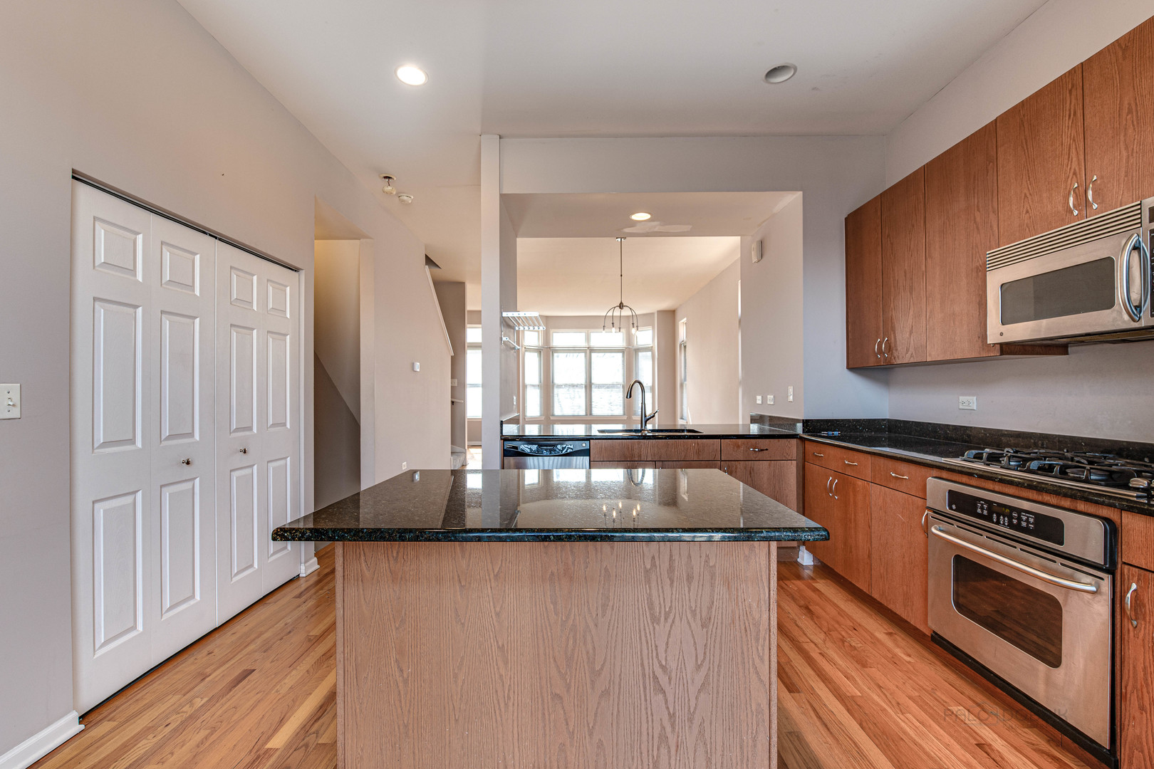 736 West 15th Street Chicago, IL 60607 - Photo 8 of 23 a kitchen with granite countertop a stove and a sink