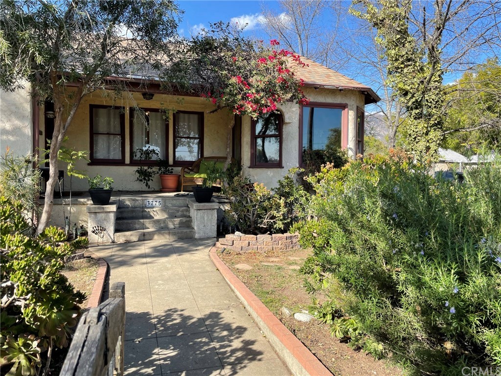 a view of a house with swimming pool and sitting area