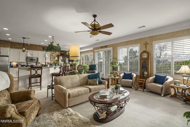 a kitchen with kitchen island a stove a center island a dining table and chairs