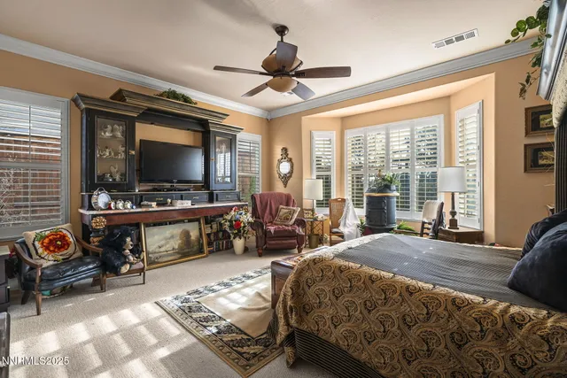 a bedroom with a bed couch and a large window