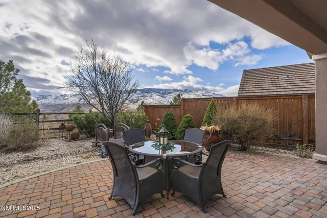 a view of a patio with a table and chairs