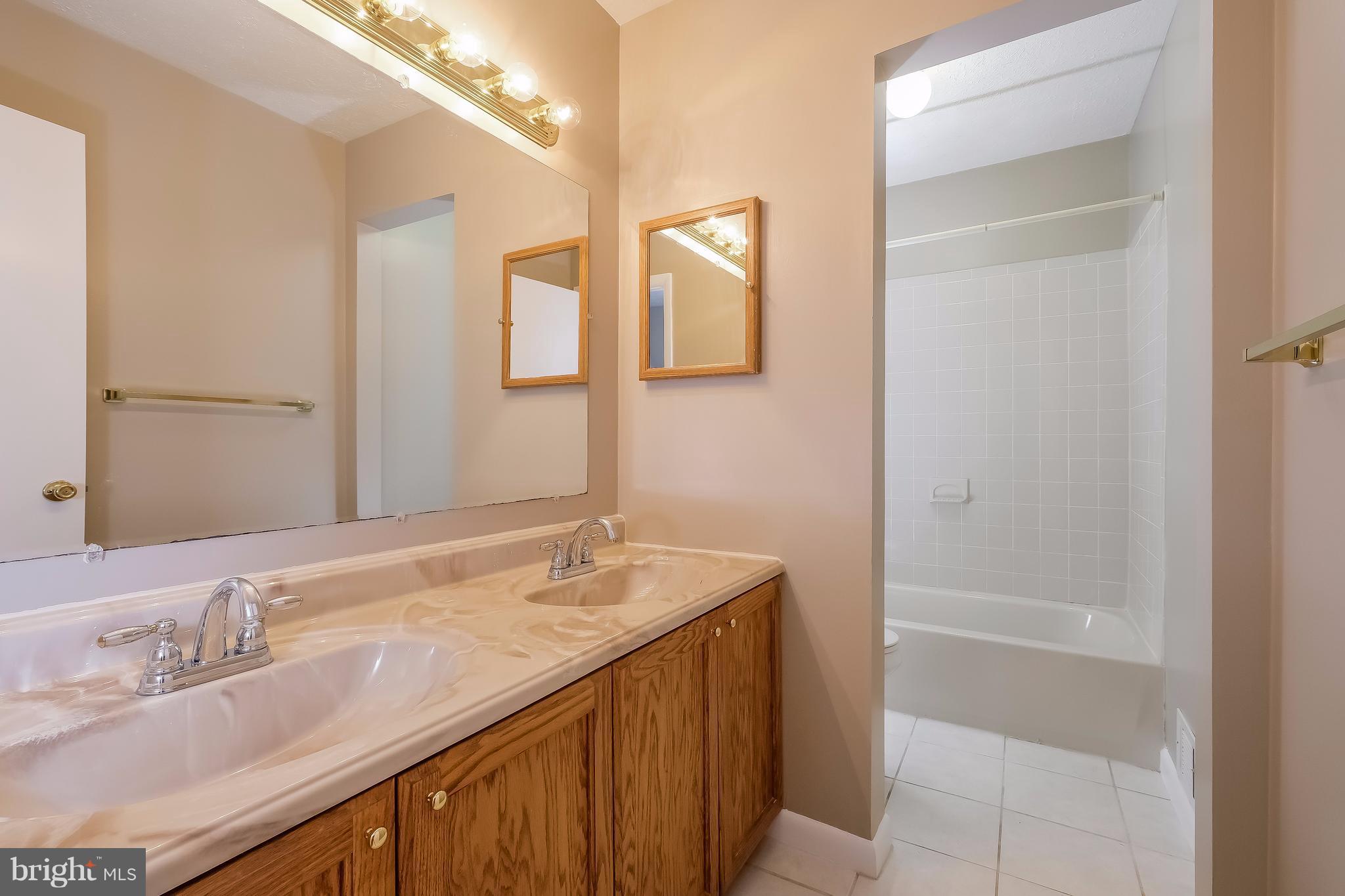 736 Ritchie Avenue Silver Spring, MD 20910 - Photo 18 of 29 a bathroom with a granite countertop sink and a mirror