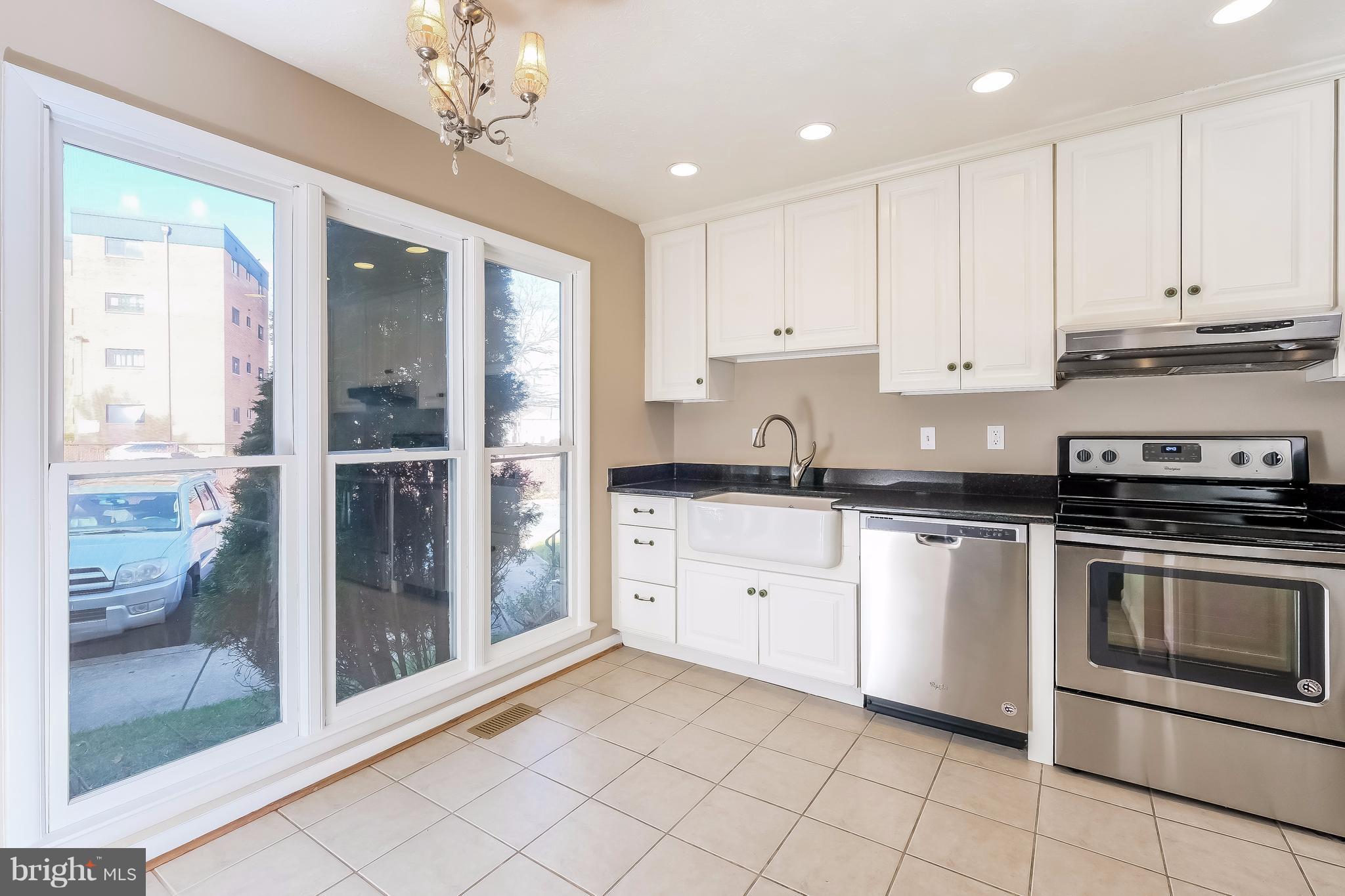 736 Ritchie Avenue Silver Spring, MD 20910 - Photo 5 of 29 a kitchen with granite countertop a stove a sink and a refrigerator
