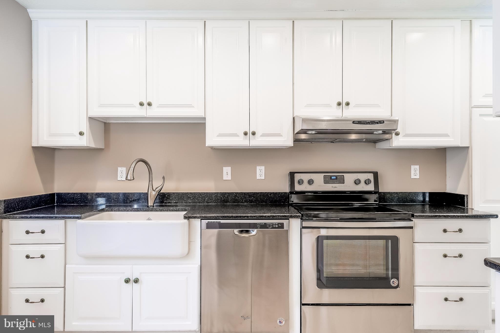 736 Ritchie Avenue Silver Spring, MD 20910 - Photo 6 of 29 a kitchen with granite countertop white cabinets and stainless steel appliances
