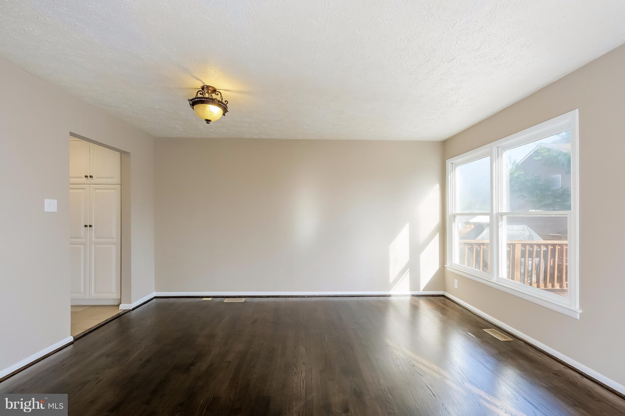 736 Ritchie Avenue Silver Spring, MD 20910 - Photo 9 of 29 an empty room with wooden floor and windows