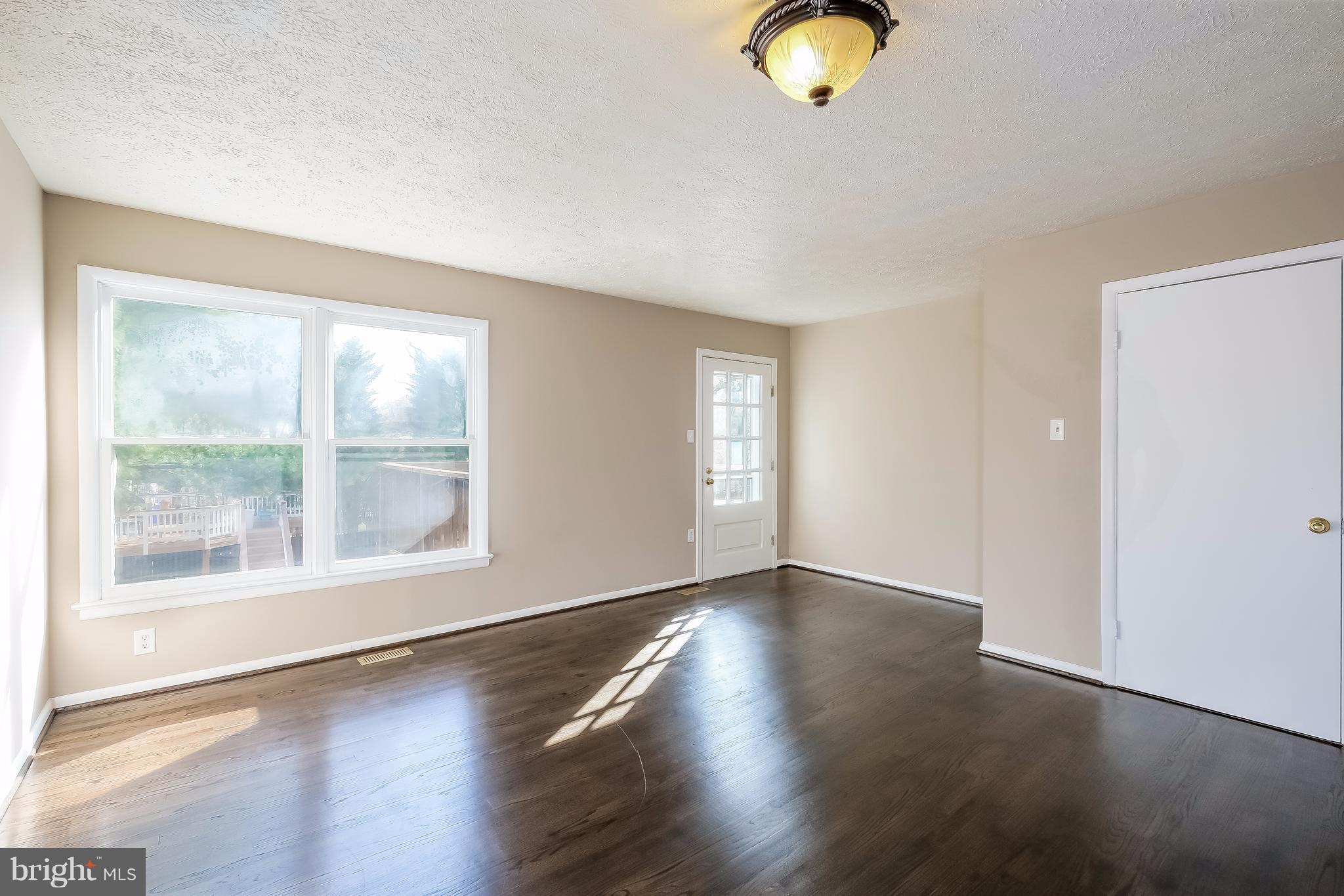 736 Ritchie Avenue Silver Spring, MD 20910 - Photo 10 of 29 a view of an empty room with wooden floor and a window