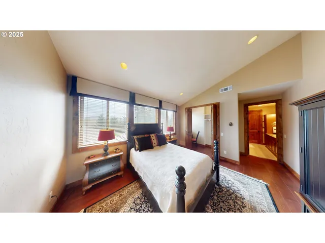 a living room with furniture a flat screen tv and a large window