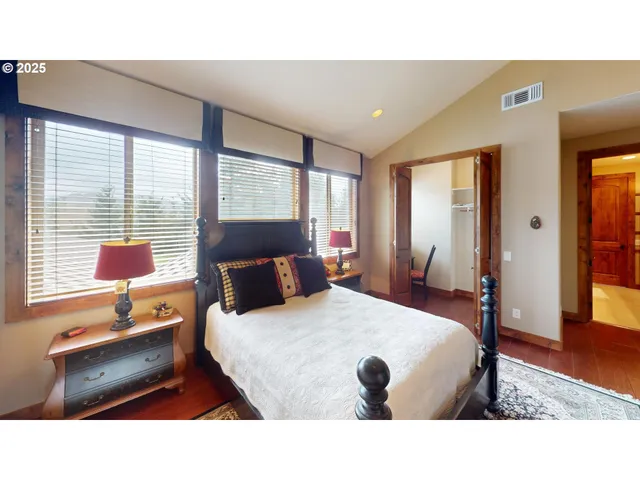 a bedroom with a bed and a desk