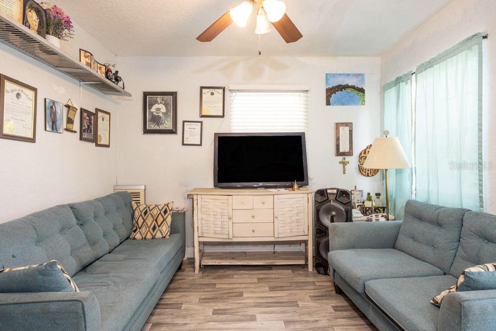 507 South Anderson Street Bunnell, FL 32110 - Photo 2 of 19 a living room with furniture and a flat screen tv