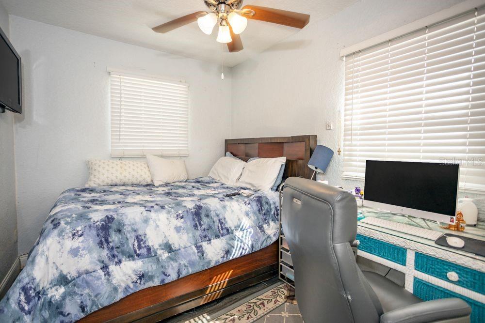 507 South Anderson Street Bunnell, FL 32110 - Photo 5 of 19 a bedroom with a bed window and a flat screen tv