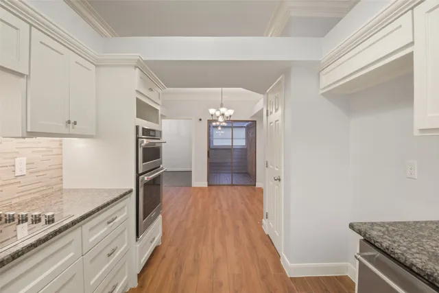a view of a kitchen cabinets and wooden floor