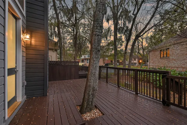 a view of balcony with wooden floor and fence