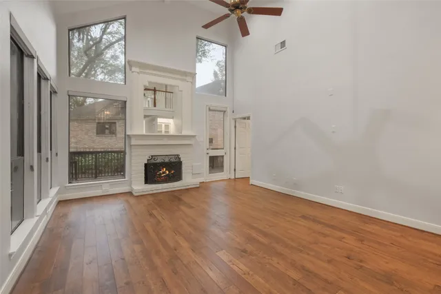 a view of an empty room with a fireplace and a window