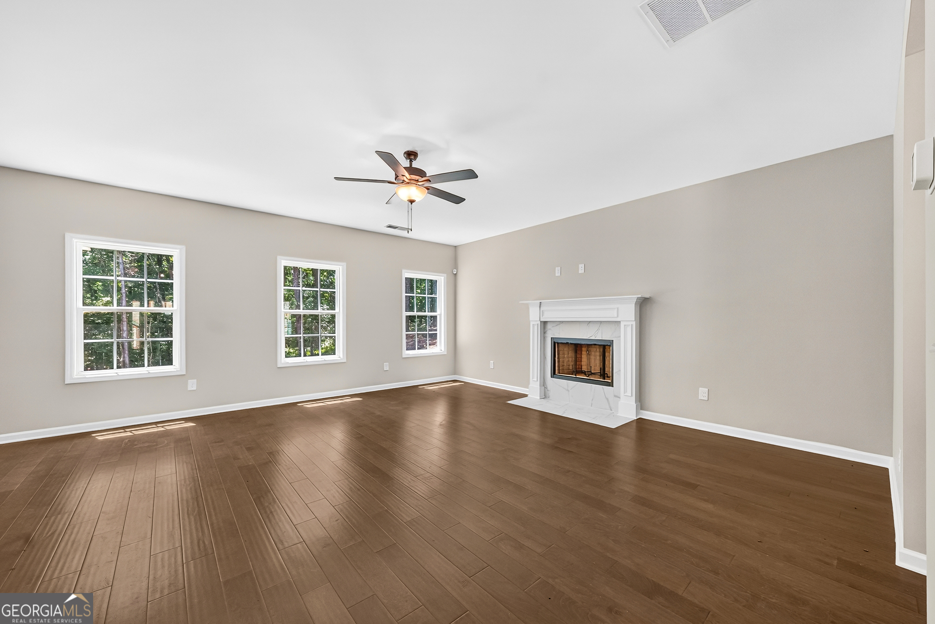 38 Oak Ridge Drive, Unit 26 Waverly Hall, GA 31831 - Photo 12 of 37 a view of an empty room with wooden floor and a window
