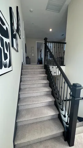 a bed sitting in a spacious bedroom next to a window