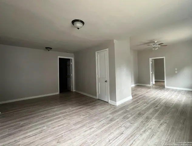 a view of an empty room and wooden floor