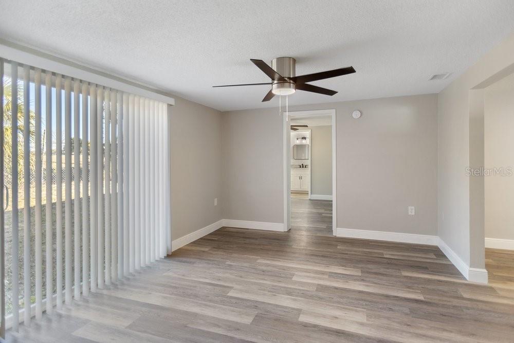 7605 Fox Hollow Drive Port Richey, FL 34668 - Photo 14 of 29 a view of empty room with wooden floor and fan